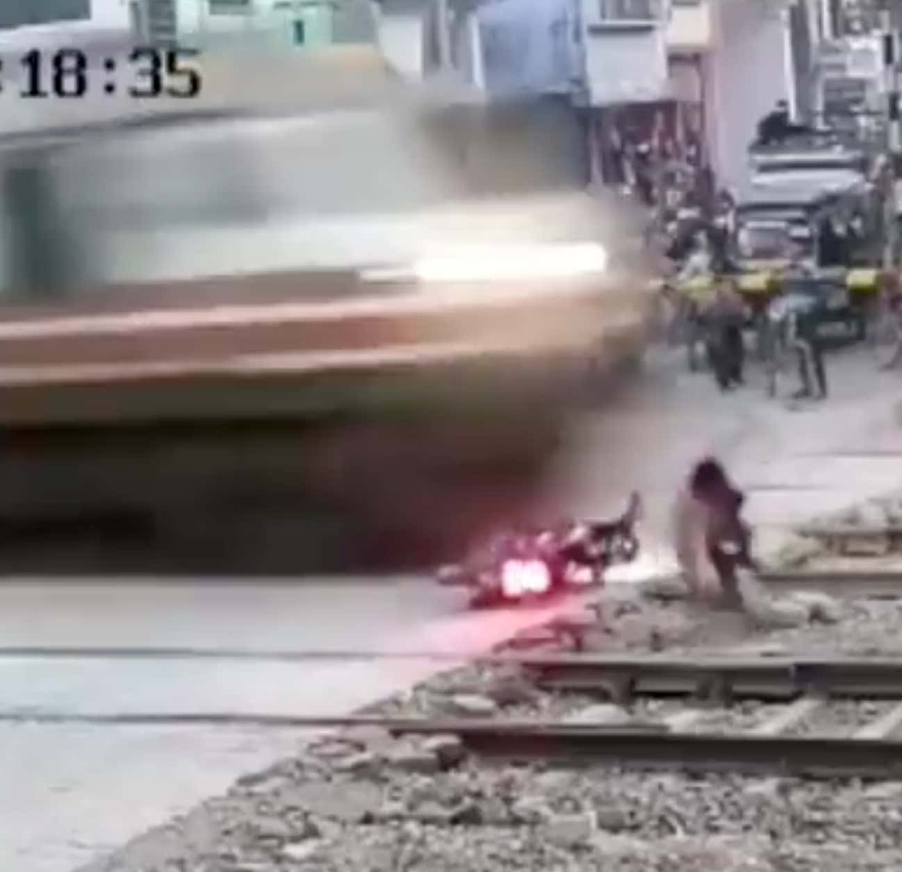 Insane Video of a Guy Bailing On His Motorcycle And Cheating Death Just a Second Before a Bullet Train Was Going To Obliterate Him