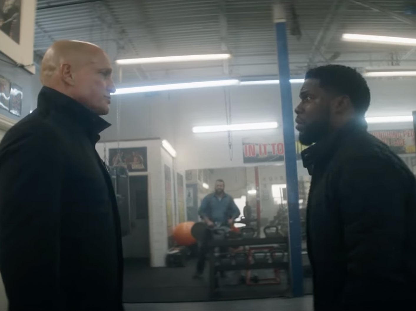 The One Shot Fight Scene From Kevin Hart And Woody Harrelson's New Movie "The Man From Toronto" With A Chainsaw, Axes, And Flying Weights Is Beautiful Chaos Unleashed