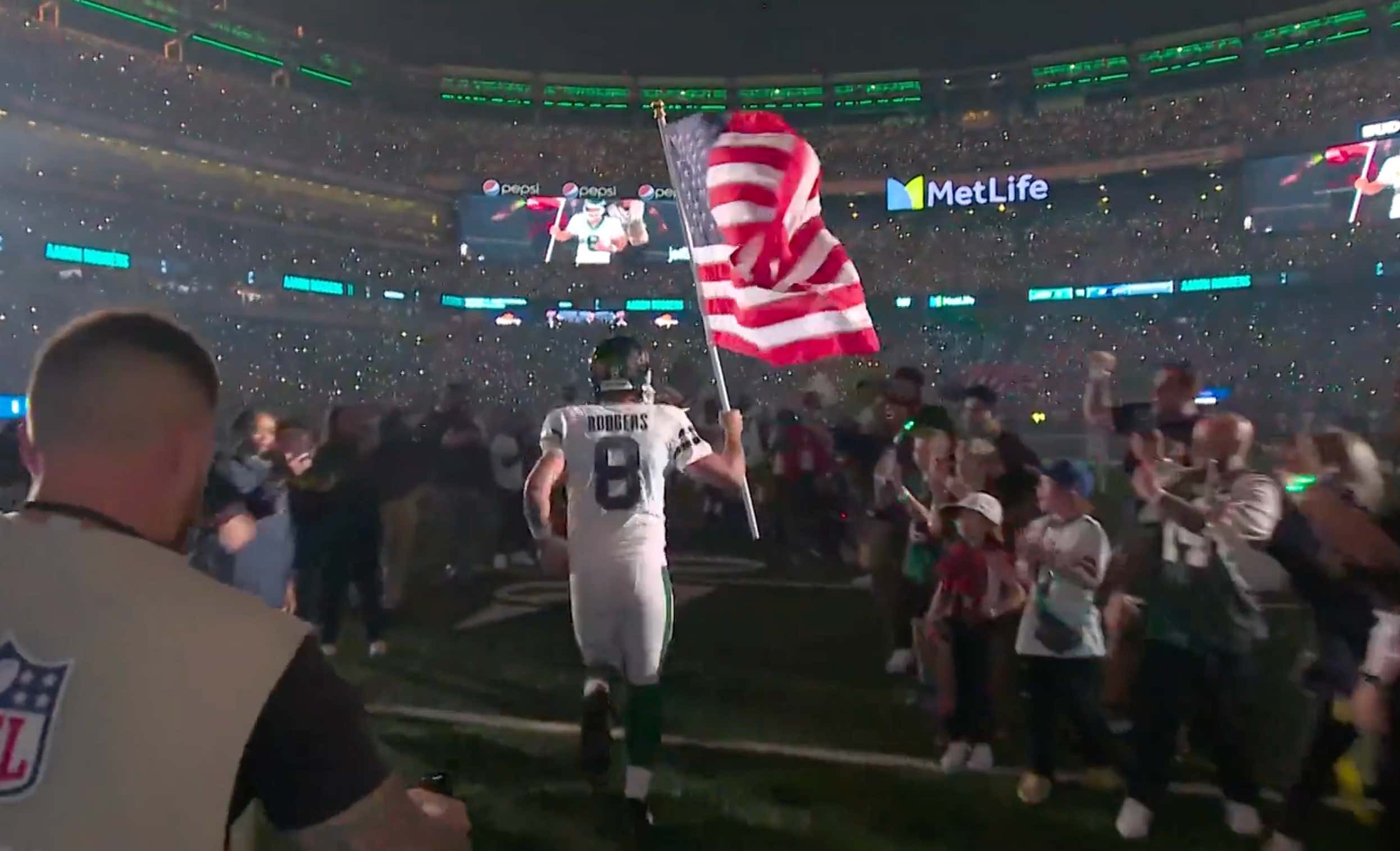 Aaron Rodgers Running Out Of The Jets Tunnel Holding The American Flag Before Monday Night Football Is As Cool As It Gets...Update: Rodgers Immediately Gets Hurt And Leaves The Game
