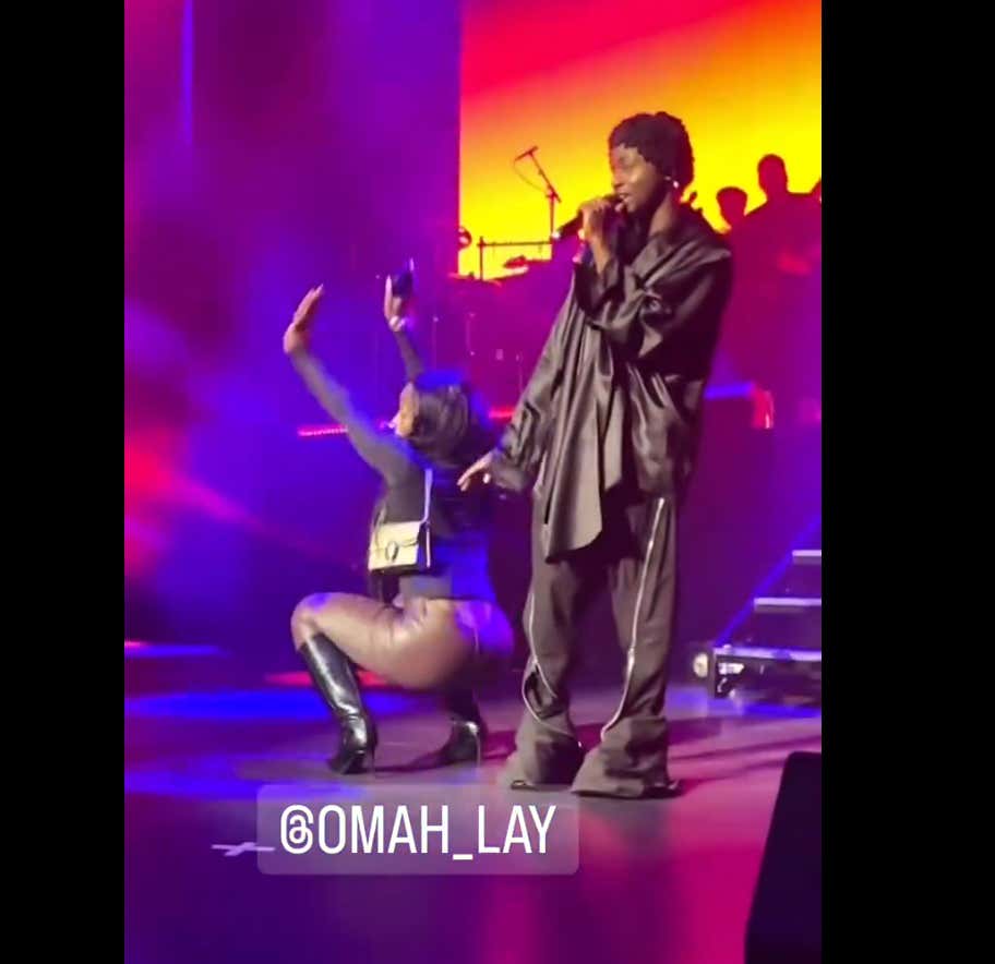 Woman Ignites Viral Debate After Leaving Her Boyfriend To Go Dance With Omah Lay On Stage