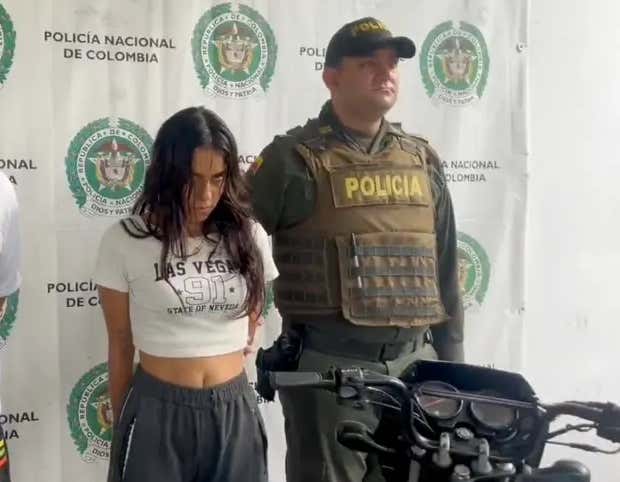 While the Manhunt for the CEO's Assassin Continues, the World Turns its Focus to Captured Columbian Hit Woman 'The Doll'