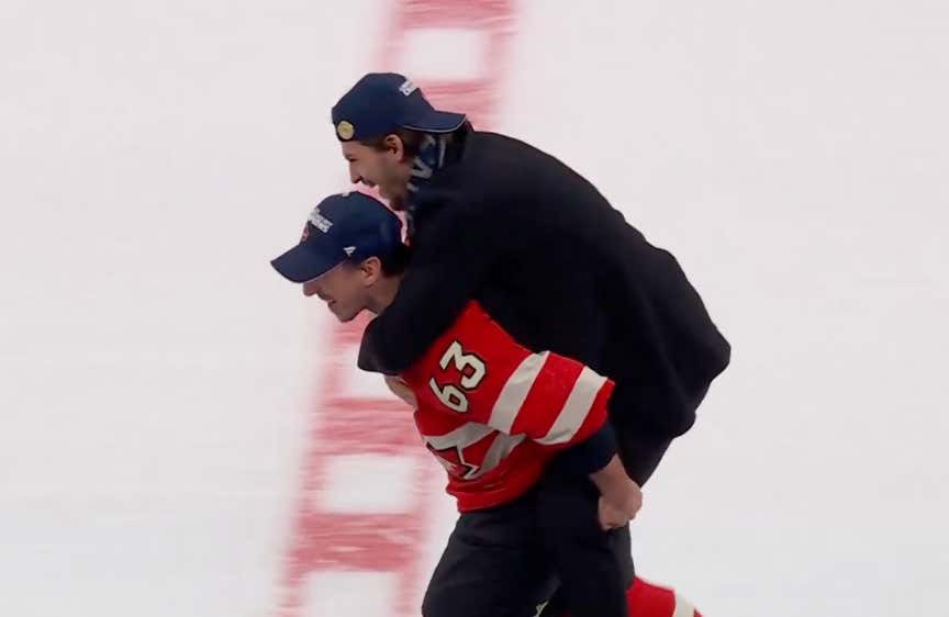 Brad Marchand Believes In "No Child Left Behind", Gives Travis Konecny A Quick Piggy Back Ride To Get His 4 Nations Medal