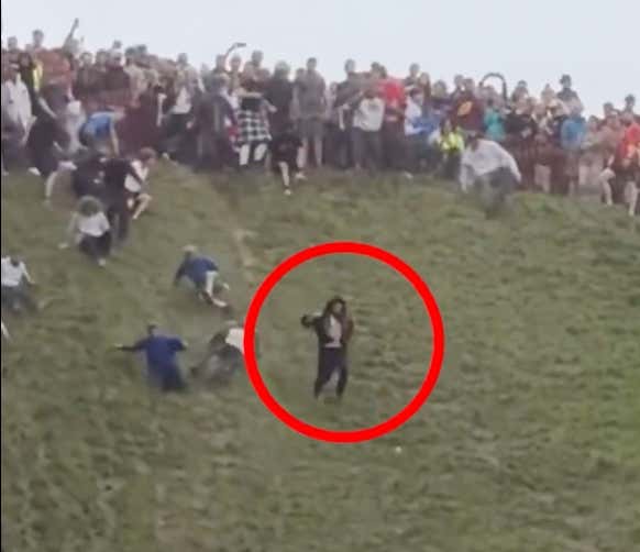 MUST WATCH: Fella Looks Like He Was Shot Out Of A Cannon Falling Down Hill At Annual Cheese Rolling Festival In England