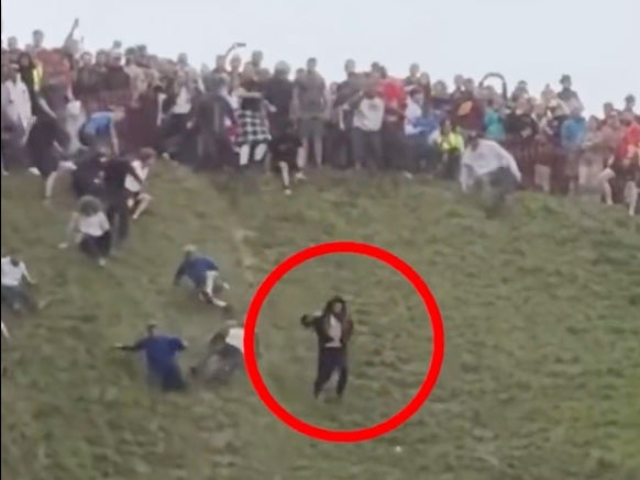 MUST WATCH: Fella Looks Like He Was Shot Out Of A Cannon Falling Down Hill At Annual Cheese Rolling Festival In England