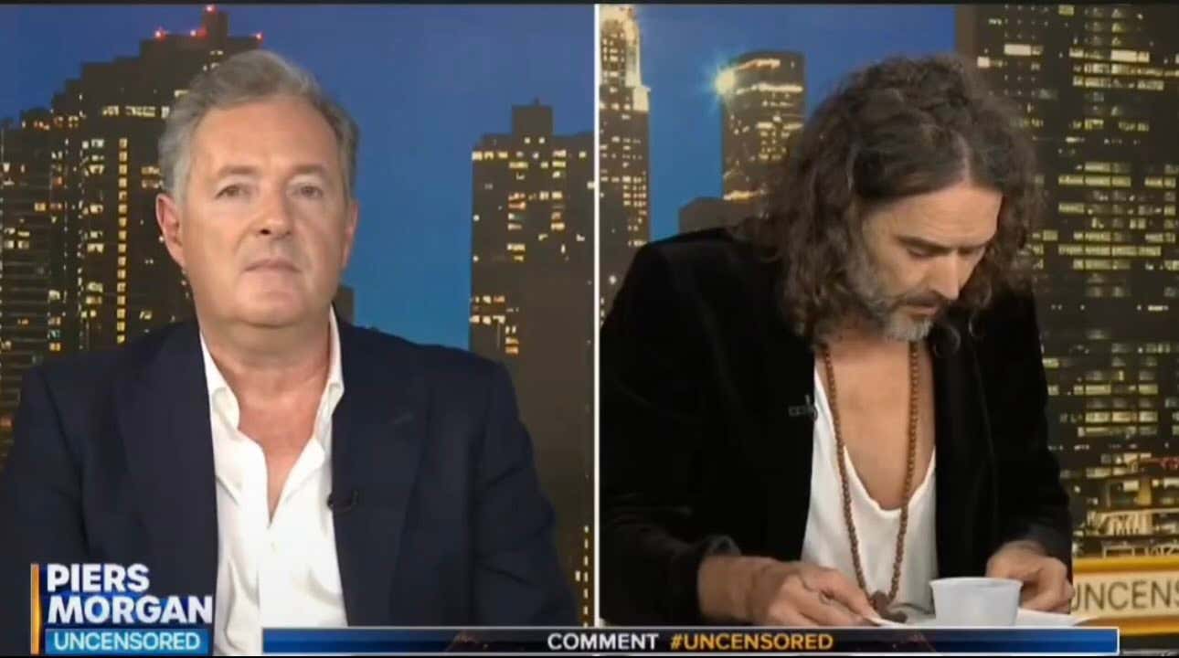 Must Watch: Russell Brand Spends Two Minutes Trying To Show Piers Morgan His Favorite Passage From The Bible He's Been Carrying Around And DEFINITELY Reading
