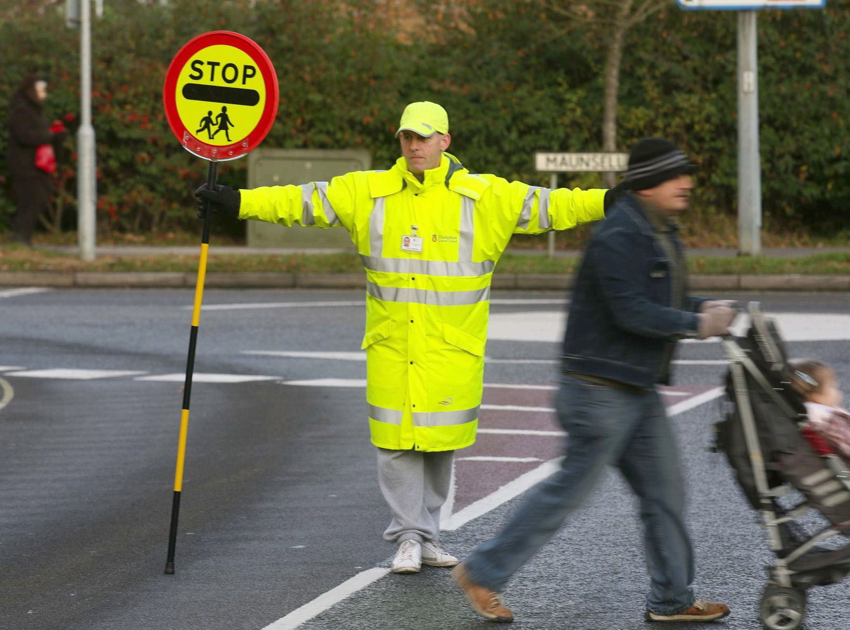 Embrace Debate: Should A Friendly "Lollipop Man" Be Allowed to Give High Fives to Children as They Cross The Street, Further Delaying Cars Who Sit Waiting at The Intersection